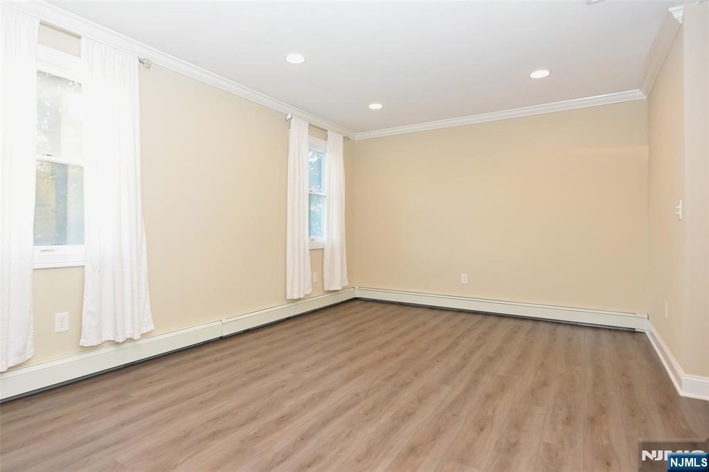105 Parkway Rochelle Park, NJ 07662 - Photo 18 of 22 a view of an empty room with wooden floor and a window