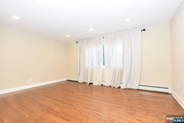 a view of wooden floor and entryway in a room