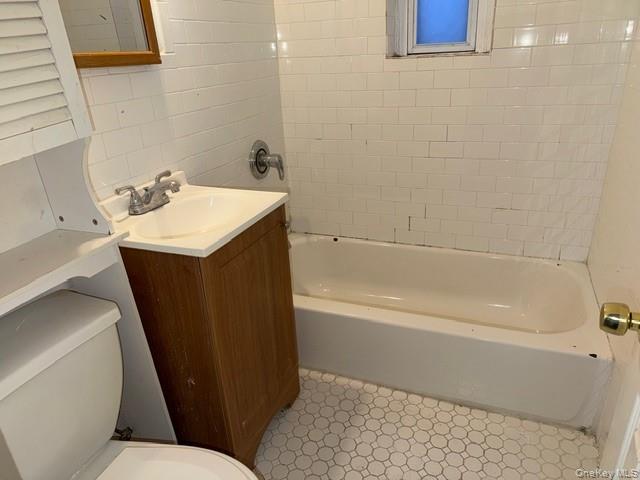 2832 Harding Avenue Bronx, NY 10465 - Photo 13 of 23 a bathroom with a sink a toilet and bathtub