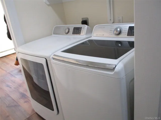 a bathroom with a granite countertop sink and a bathtub