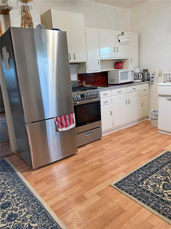 29088 County Road South Karval, CO 80823 - Photo 13 of 37 a kitchen with granite countertop a refrigerator stove and sink