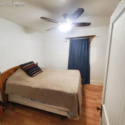 a bed sitting in a bedroom next to a bathroom sink