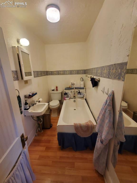 29088 County Road South Karval, CO 80823 - Photo 19 of 37 a bed sitting in a bedroom next to a bathroom sink