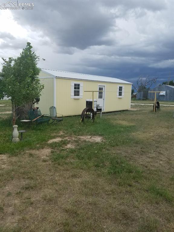 29088 County Road South Karval, CO 80823 - Photo 21 of 37 a backyard of a house with table and chairs