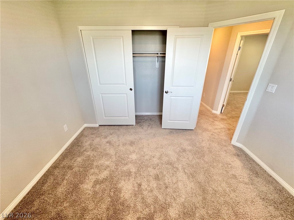 7020 Colonial Ranch Street Las Vegas, NV 89166 - Photo 30 of 37 Plush carpeting and a built-in closet complete this comfortable secondary bedroom space.