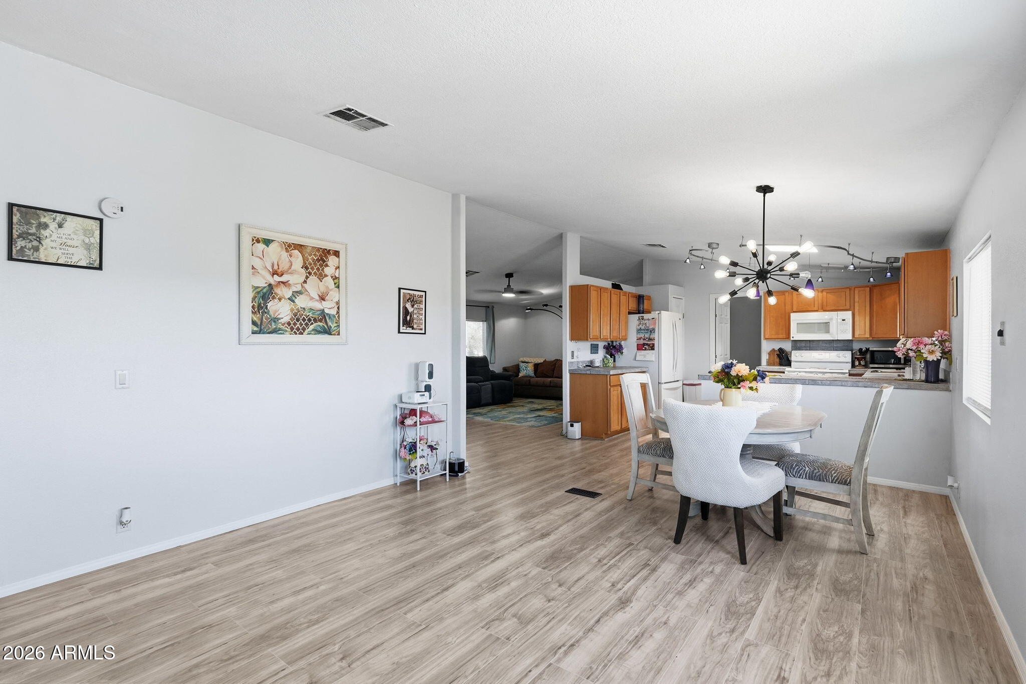 816 North Ridgeview Place Huachuca City, AZ 85616 - Photo 13 of 46 a view of a dining room with furniture and wooden floor