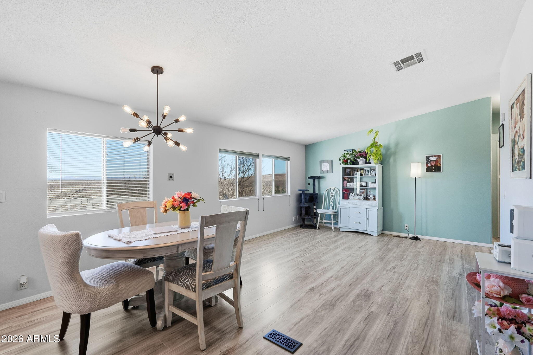 816 North Ridgeview Place Huachuca City, AZ 85616 - Photo 14 of 46 a view of a dining room with furniture and a chandelier