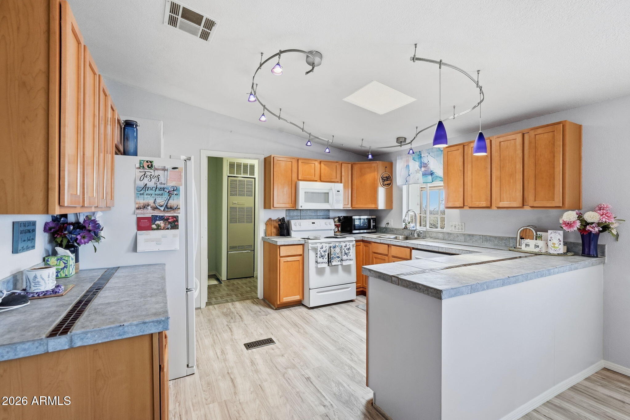 816 North Ridgeview Place Huachuca City, AZ 85616 - Photo 16 of 46 a kitchen that has a lot of cabinets in it