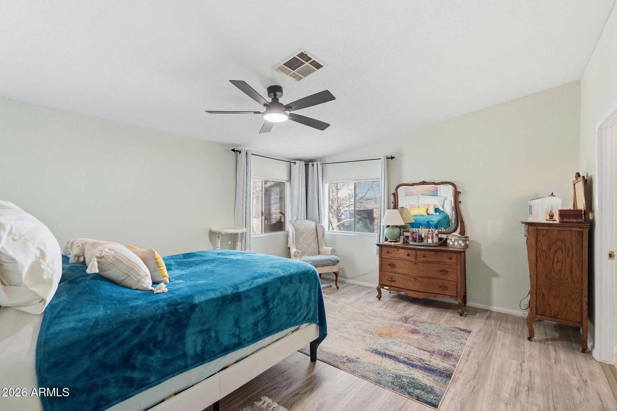 816 North Ridgeview Place Huachuca City, AZ 85616 - Photo 21 of 46 a bedroom with a bed and wooden floor