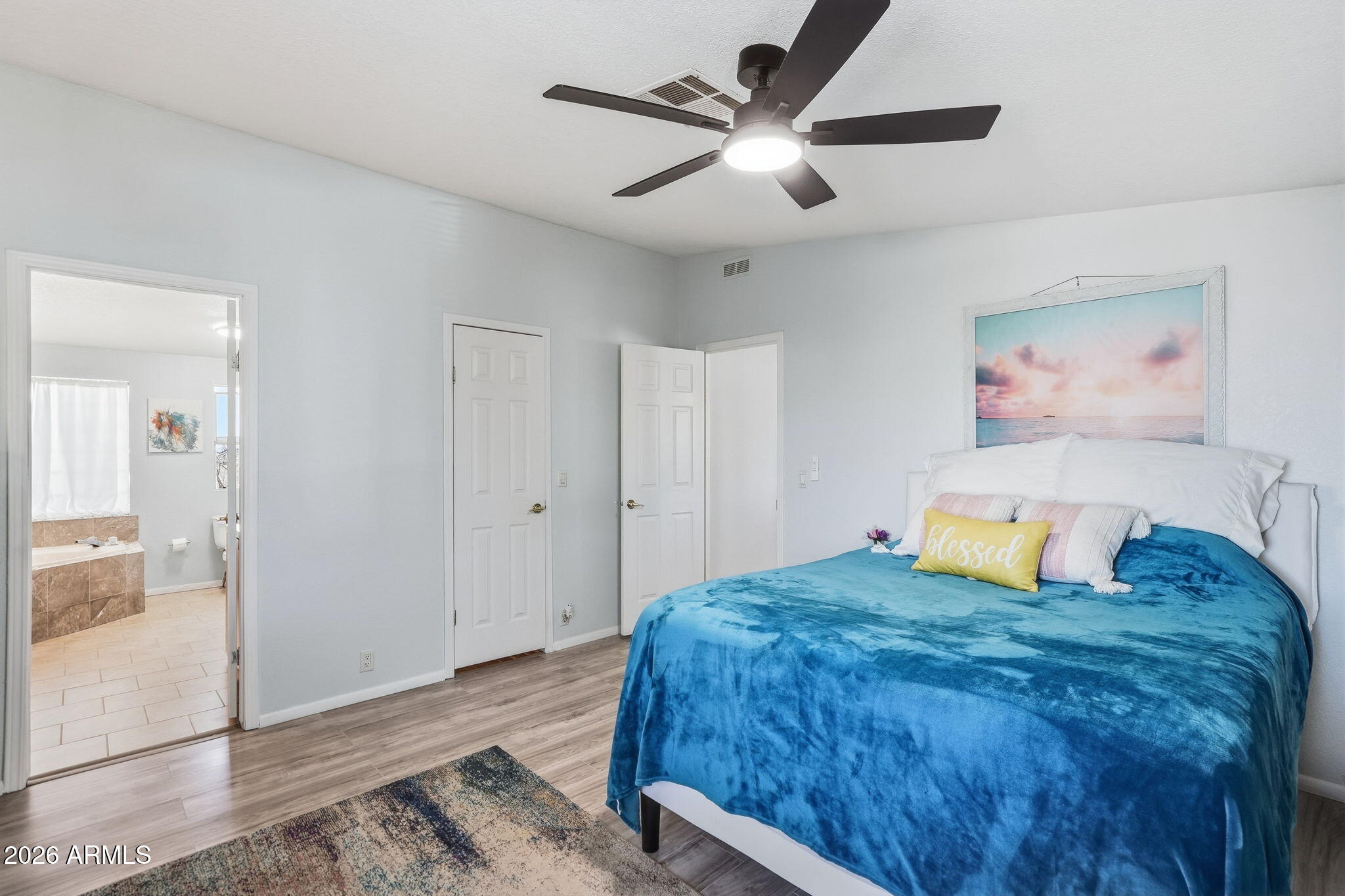 816 North Ridgeview Place Huachuca City, AZ 85616 - Photo 23 of 46 a bedroom with a large bed and a chandelier