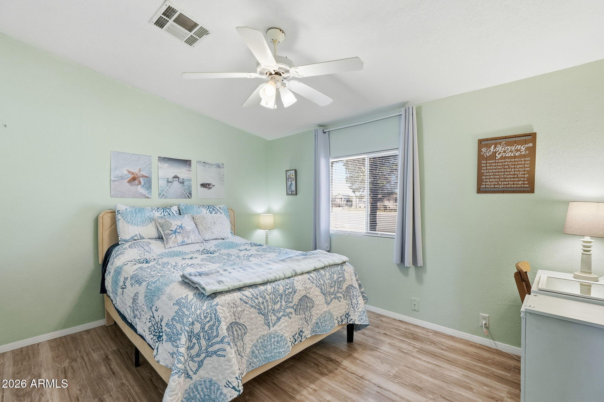 816 North Ridgeview Place Huachuca City, AZ 85616 - Photo 28 of 46 a bedroom with a large bed and a chandelier