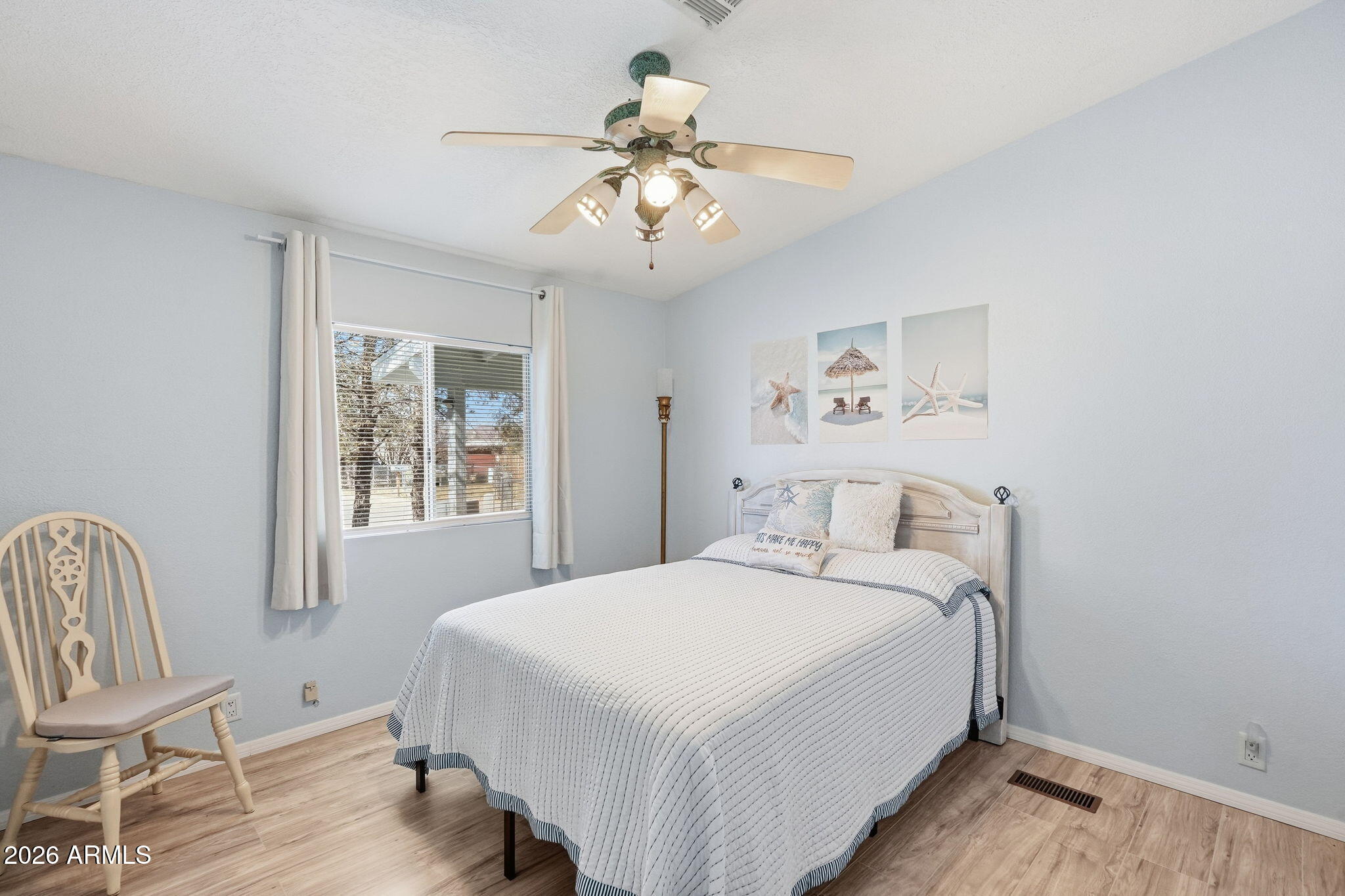816 North Ridgeview Place Huachuca City, AZ 85616 - Photo 32 of 46 a bedroom with a bed and a chair