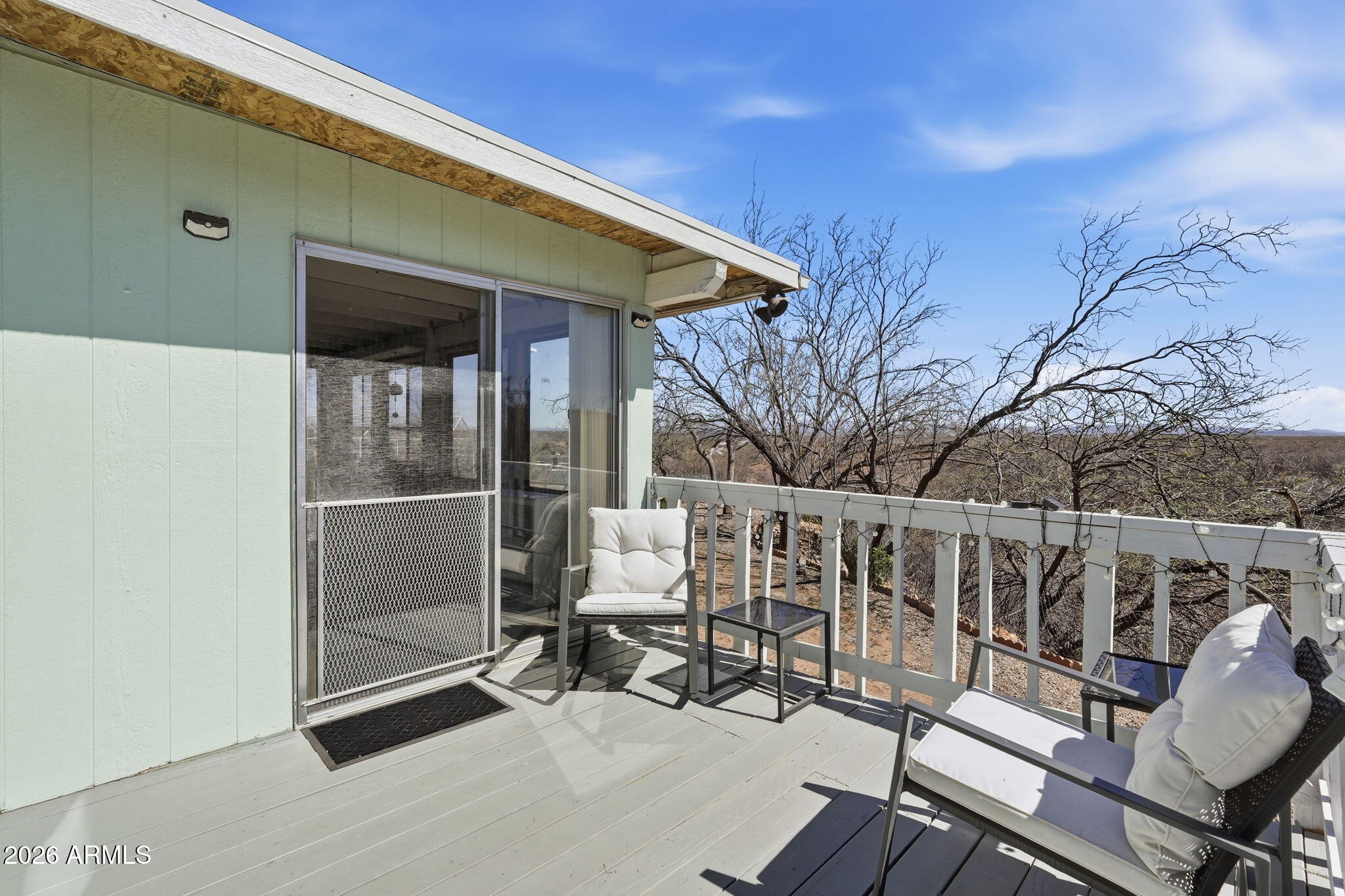 816 North Ridgeview Place Huachuca City, AZ 85616 - Photo 41 of 46 a roof deck with table and chairs and wooden floor