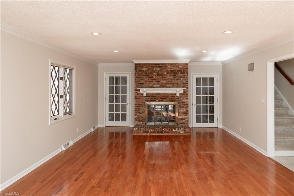 7204 Haw Ridge Road Summerfield, NC 27358 - Photo 3 of 43 2-Sided woodburning bricked fireplace adds charm to living room and breakfast room