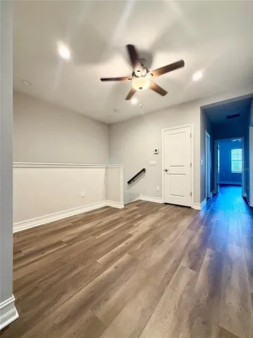 a view of an empty room and wooden floor