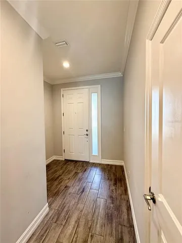 a view of a room with wooden floor and window