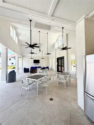 a living room with furniture a fireplace and a chandelier