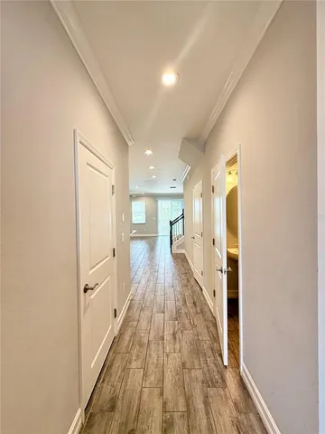 a view of a hallway with wooden floor