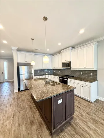 a kitchen with a stove a sink and a refrigerator