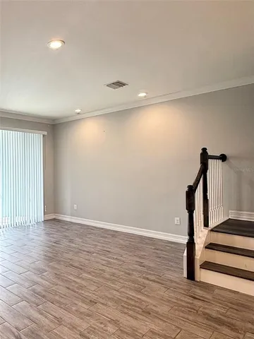 a view of a room with wooden floor