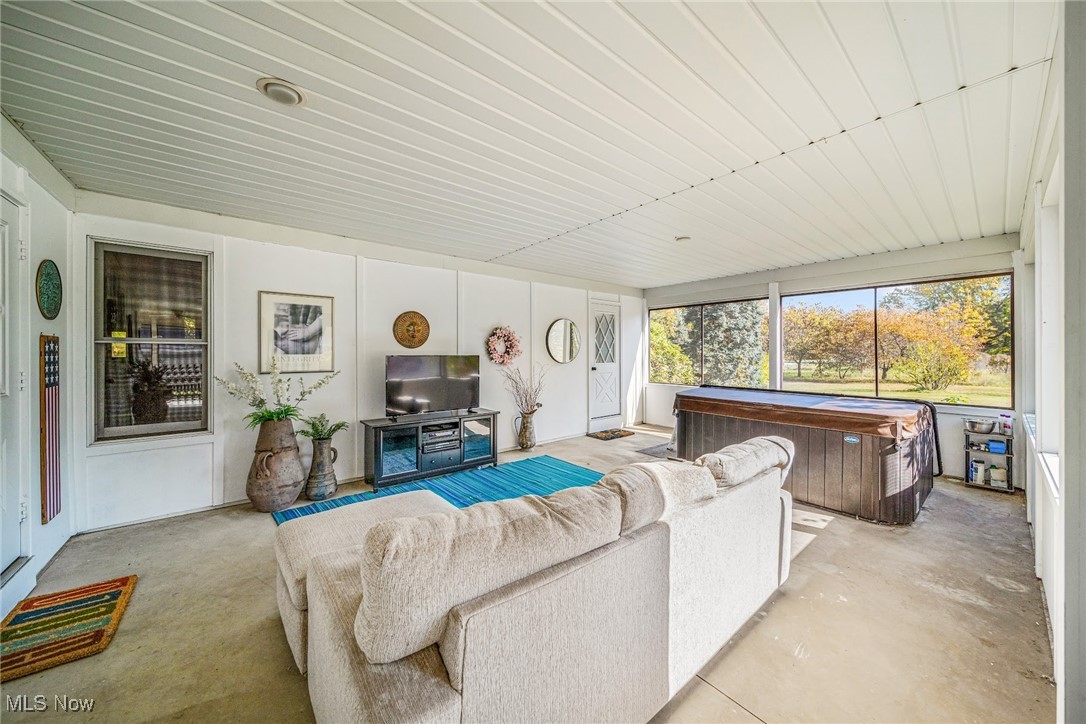 6834 Chapel Road Madison, OH 44057 - Photo 15 of 48 Wrap-around, enclosed porch with spa entrance at primary suite