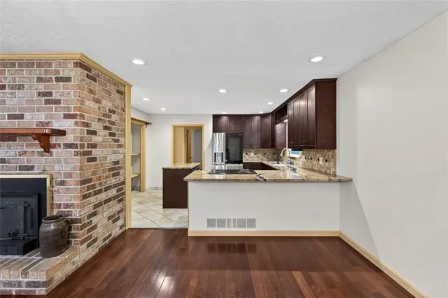 a view of kitchen with sink and wooden floor