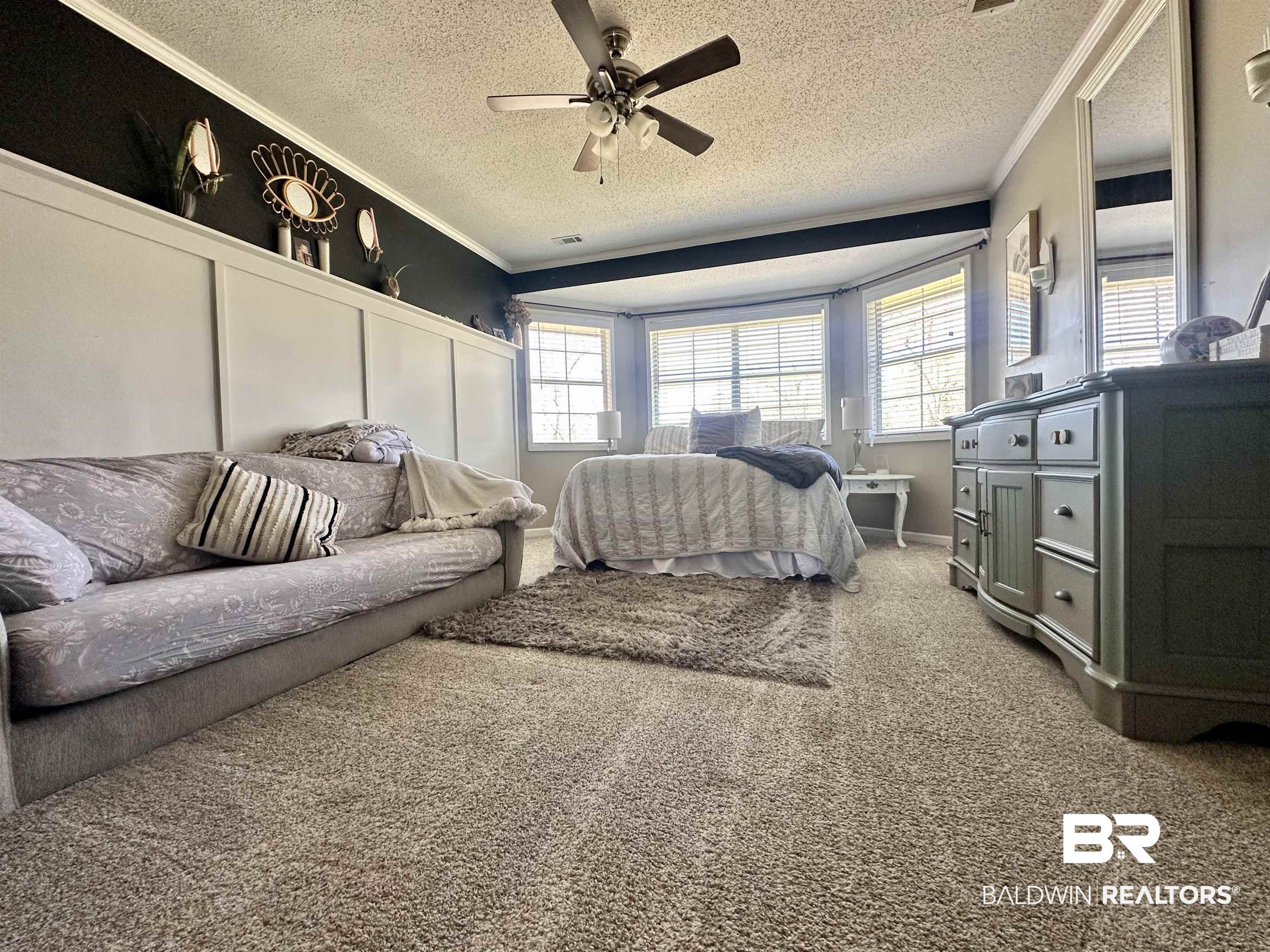 120 McGougin Road Brewton, AL 36426 - Photo 12 of 21 Bedroom featuring carpet, ornamental molding, ceiling fan, and a textured ceiling