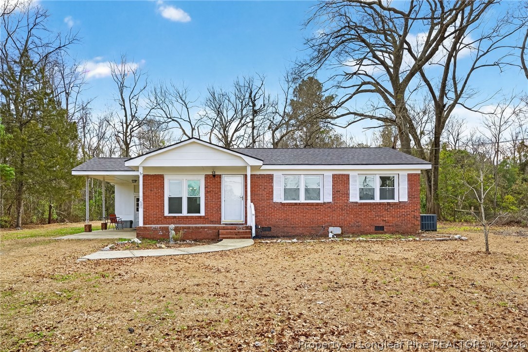 1586 Tom Starling Road Fayetteville, NC 28306 - Photo 1 of 44 a front view of a house with a yard and trees