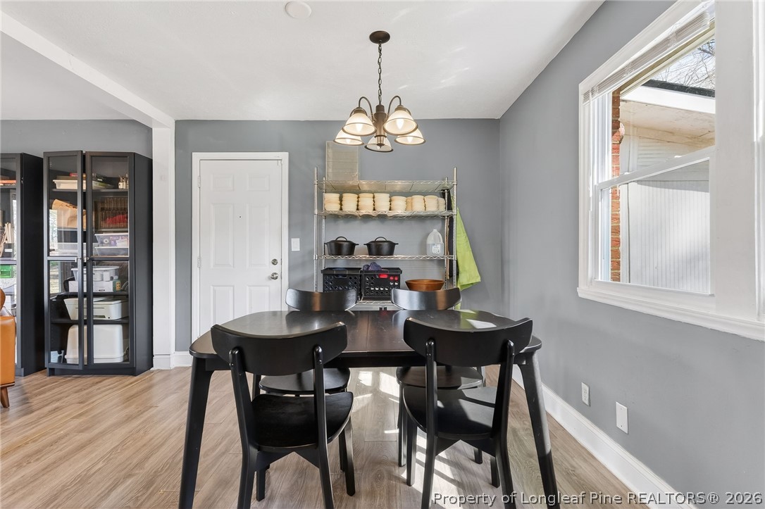 1586 Tom Starling Road Fayetteville, NC 28306 - Photo 11 of 44 a view of a dining room with furniture window and wooden floor
