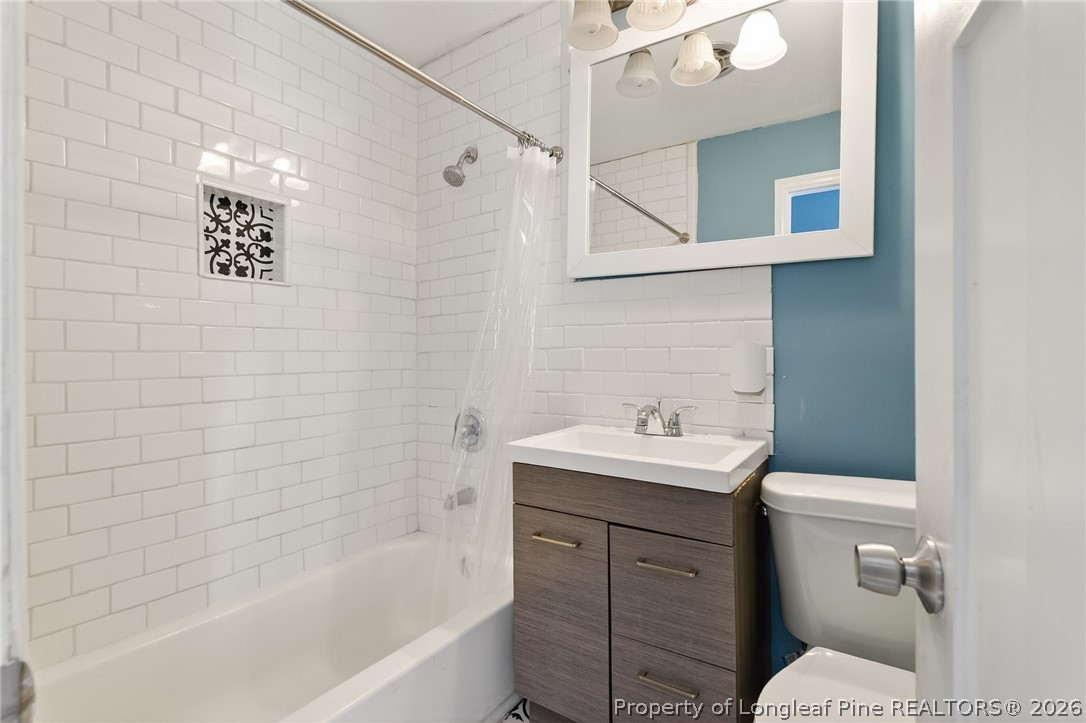 1586 Tom Starling Road Fayetteville, NC 28306 - Photo 18 of 44 a bathroom with a sink a toilet and shower