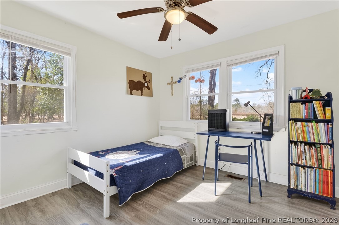 1586 Tom Starling Road Fayetteville, NC 28306 - Photo 21 of 44 a living room with furniture a window and a bookshelf