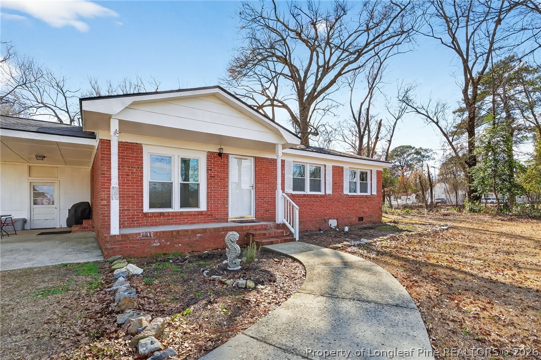 1586 Tom Starling Road Fayetteville, NC 28306 - Photo 5 of 44 a front view of a house with a yard