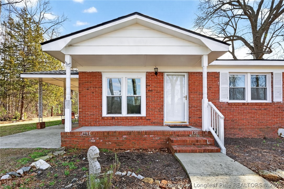 1586 Tom Starling Road Fayetteville, NC 28306 - Photo 6 of 44 a front view of a house with a yard