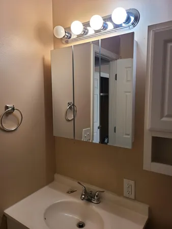 a bathroom with a sink vanity and mirror