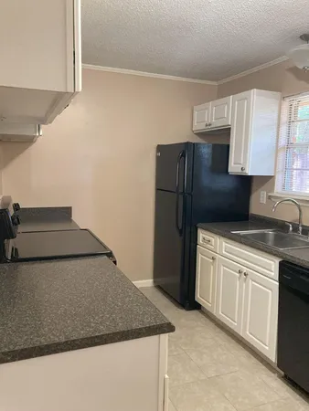 a kitchen with a sink and a refrigerator