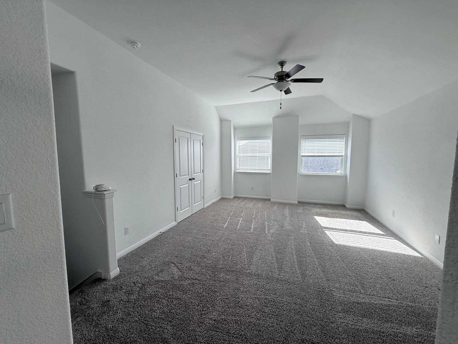 160 Venti Cove Georgetown, TX 78628 - Photo 11 of 40 an empty room with windows and fan