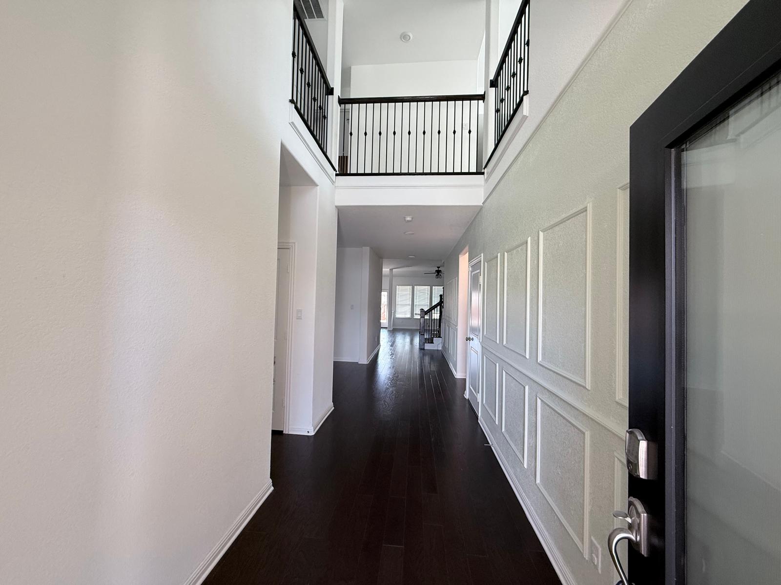 160 Venti Cove Georgetown, TX 78628 - Photo 17 of 40 a view of staircase with lots of frames on wall and wooden floor