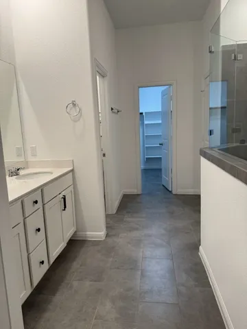 a bathroom with a double vanity sink and a mirror