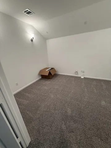 a view of a big room with closet and a ceiling fan