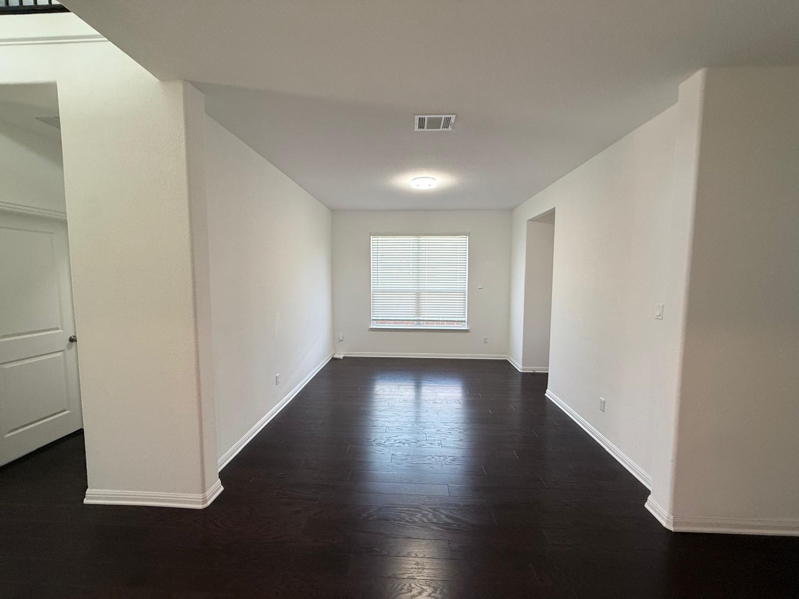 160 Venti Cove Georgetown, TX 78628 - Photo 22 of 40 an empty room with wooden floor and windows