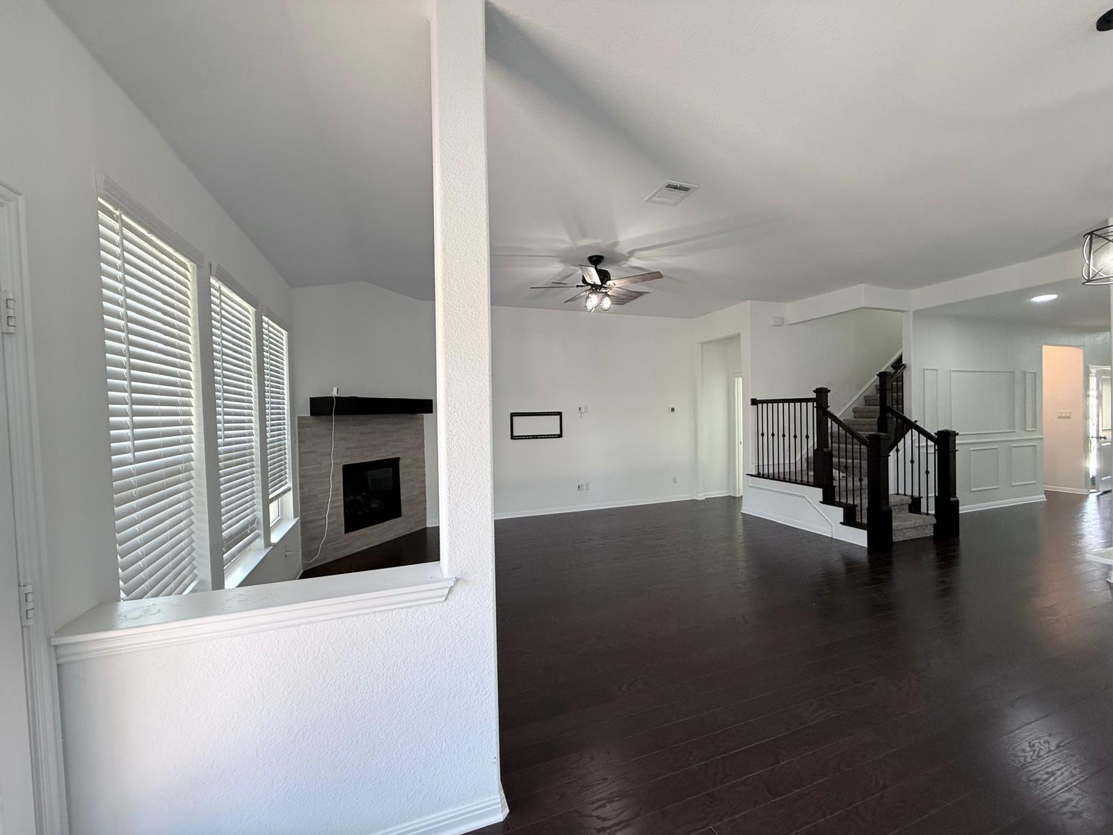 160 Venti Cove Georgetown, TX 78628 - Photo 25 of 40 a view of empty room with wooden floor and fireplace