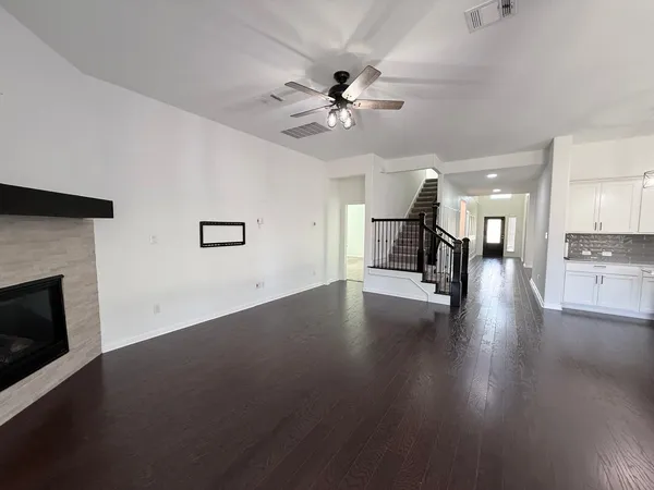 a view of a livingroom with a ceiling fan and window