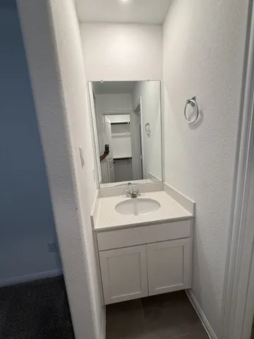 a bathroom with double sink and a mirror