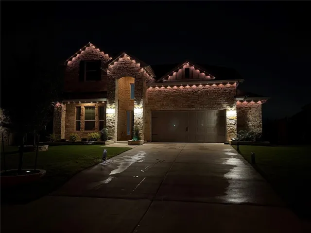 a kitchen with stainless steel appliances granite countertop a refrigerator a sink and white cabinets