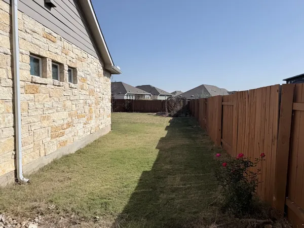 a view of a house with a yard and sitting area