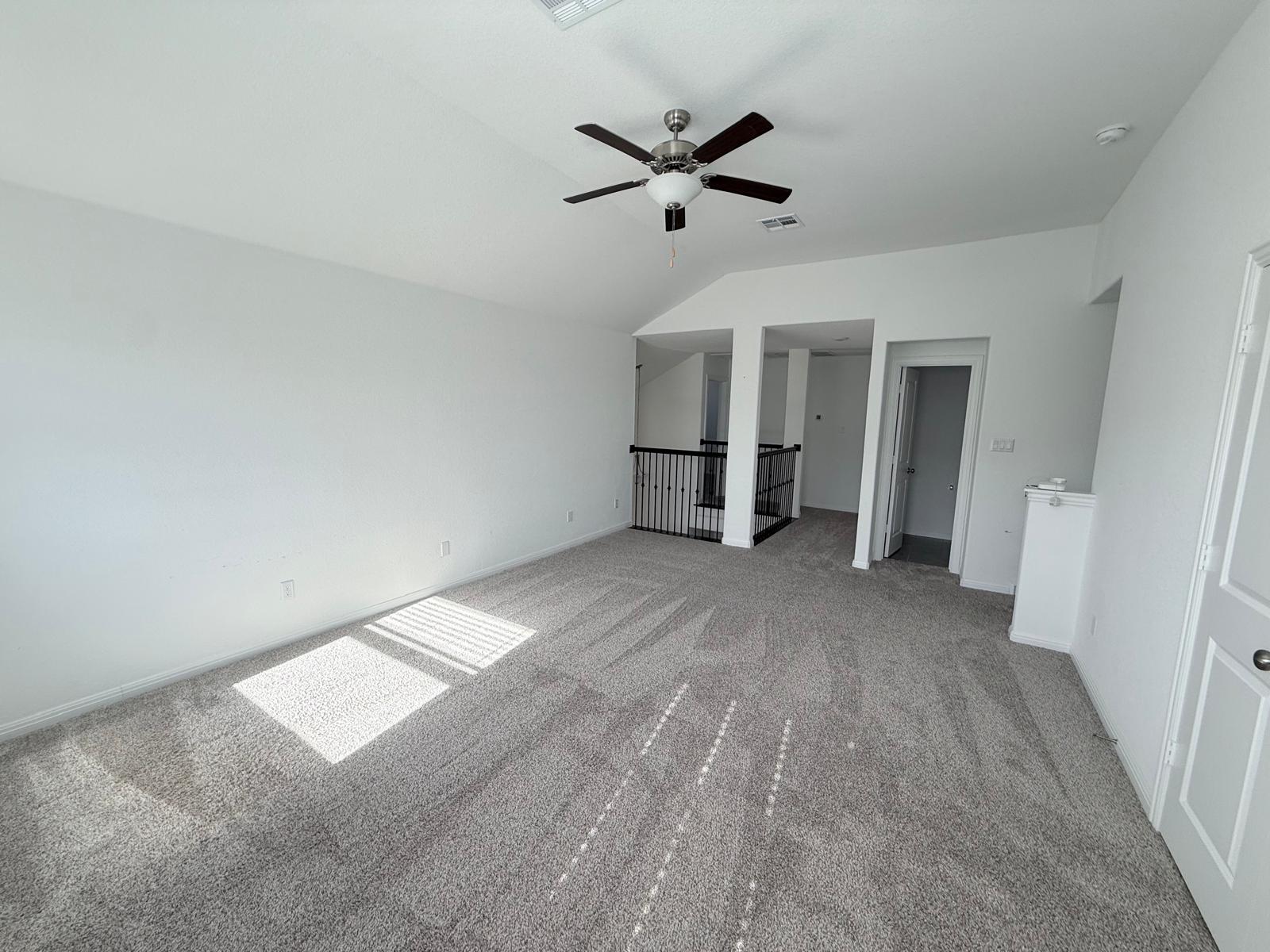 160 Venti Cove Georgetown, TX 78628 - Photo 10 of 40 an empty room with a ceiling fan and wooden floor