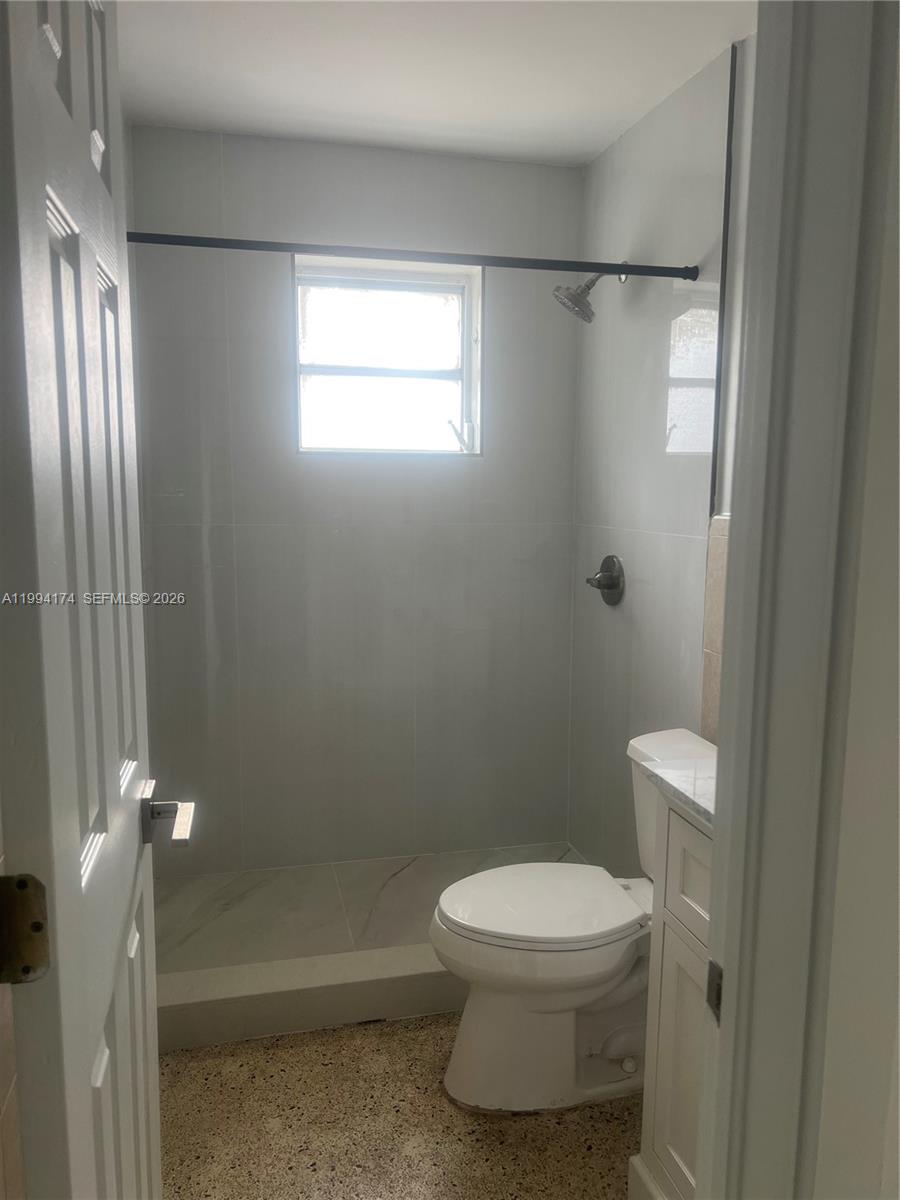 3279 Southwest 25th Terrace, Unit 3279 Miami, FL 33133 - Photo 3 of 6 a white toilet sitting next to a bathroom sink