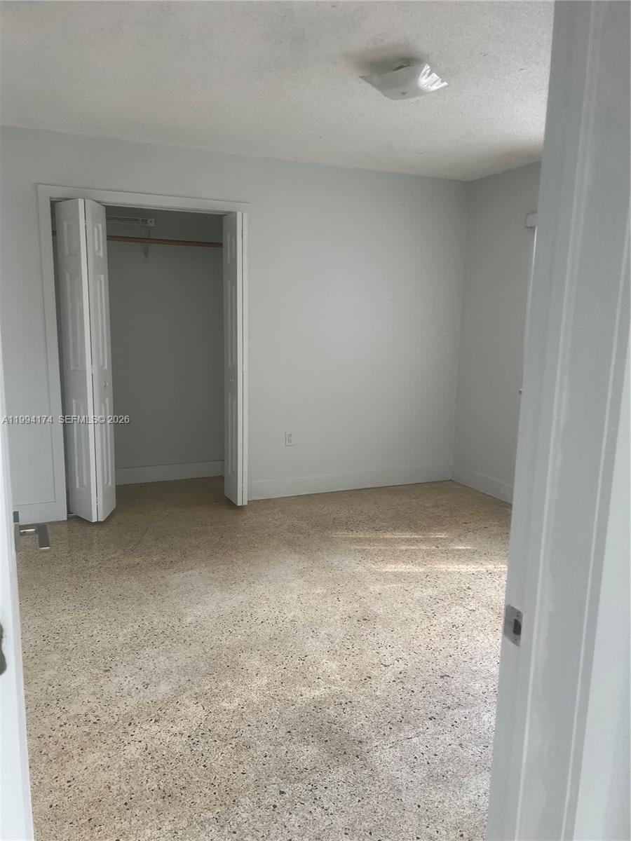 3279 Southwest 25th Terrace, Unit 3279 Miami, FL 33133 - Photo 5 of 6 an empty room with closet