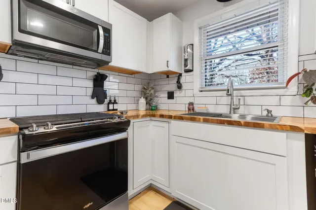 a front view of a house with yard and green space