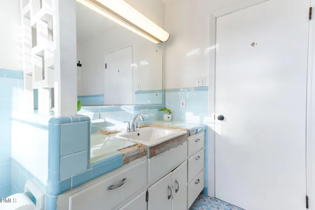 a bedroom with a bed chair and a window